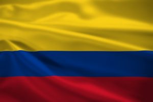 Colombia flag blowing in the wind. Background texture.
